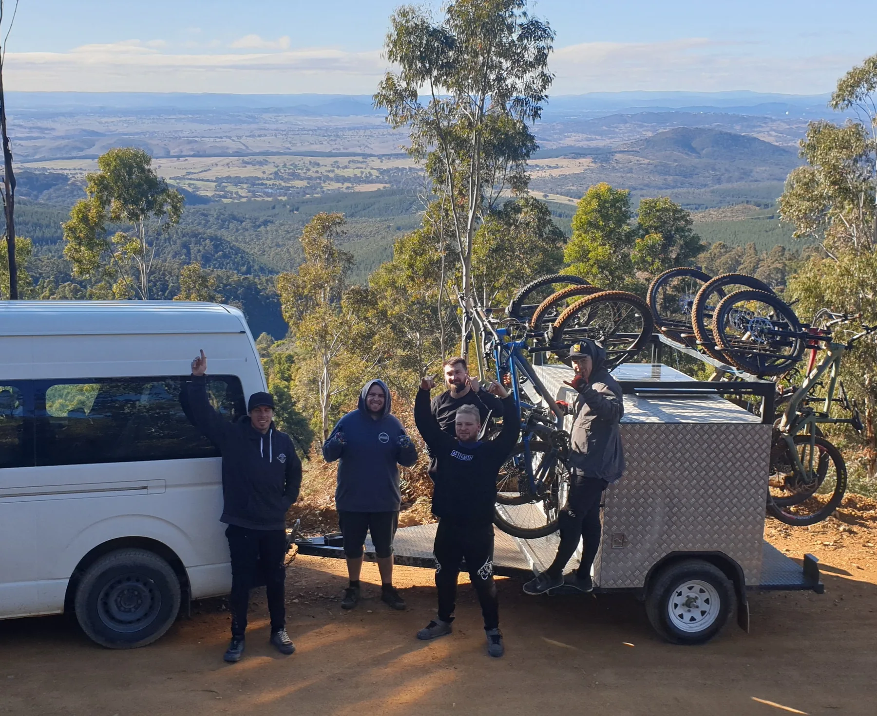 The Granted Ride bus and loaded trailer parked at a lookout above the valley