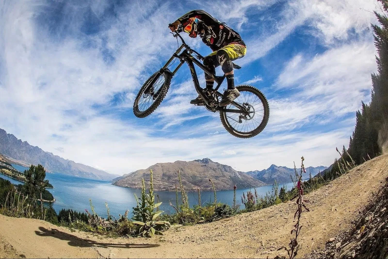 A rider whips a jump high above Lake Wakatipu, Queenstown